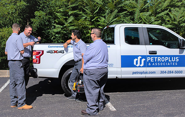 Maintenance crew standing around pickup truck