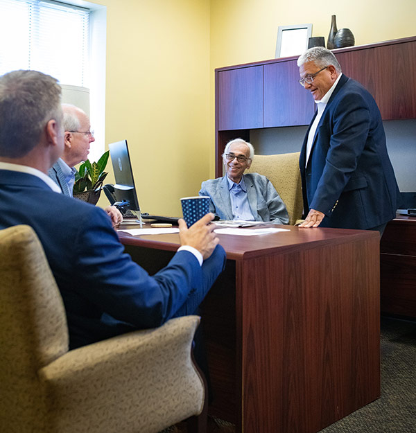 Men gathered in an office